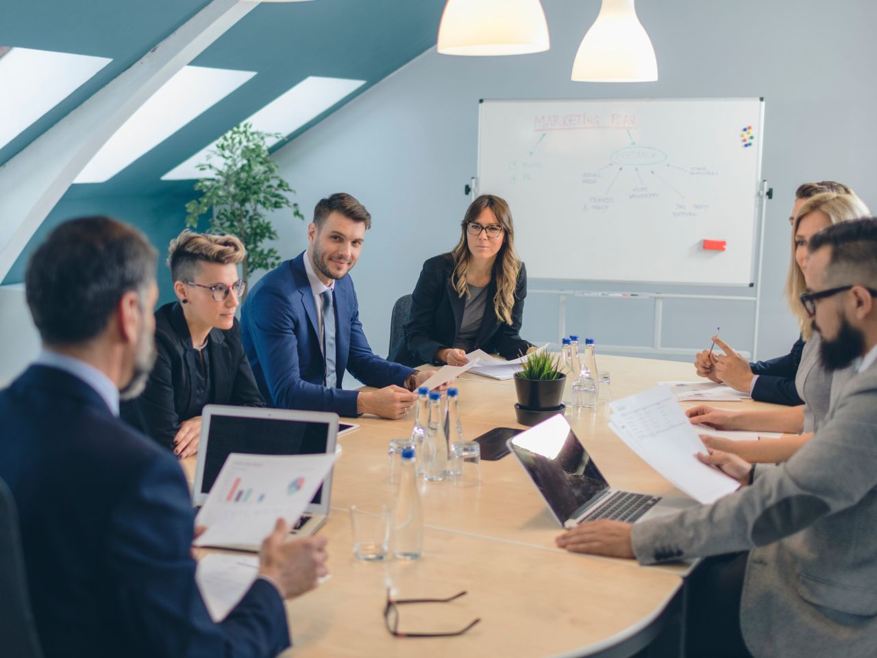 Executive team reviewing risk analytics in boardroom meeting