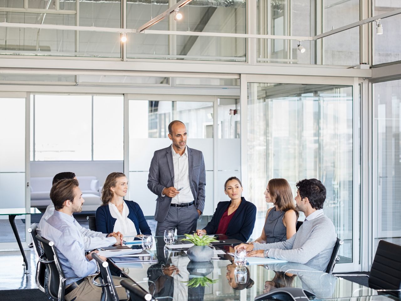 Business leaders analyzing trend reports and risk patterns in meeting